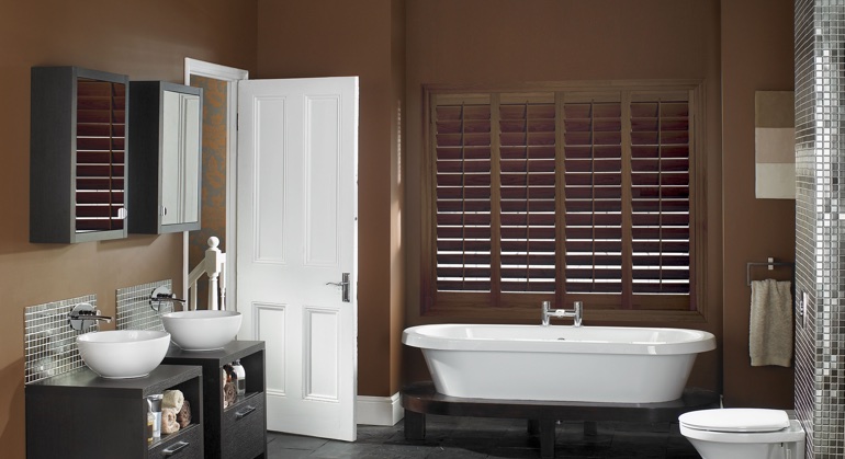 Stained wood shutter in Southern California restroom